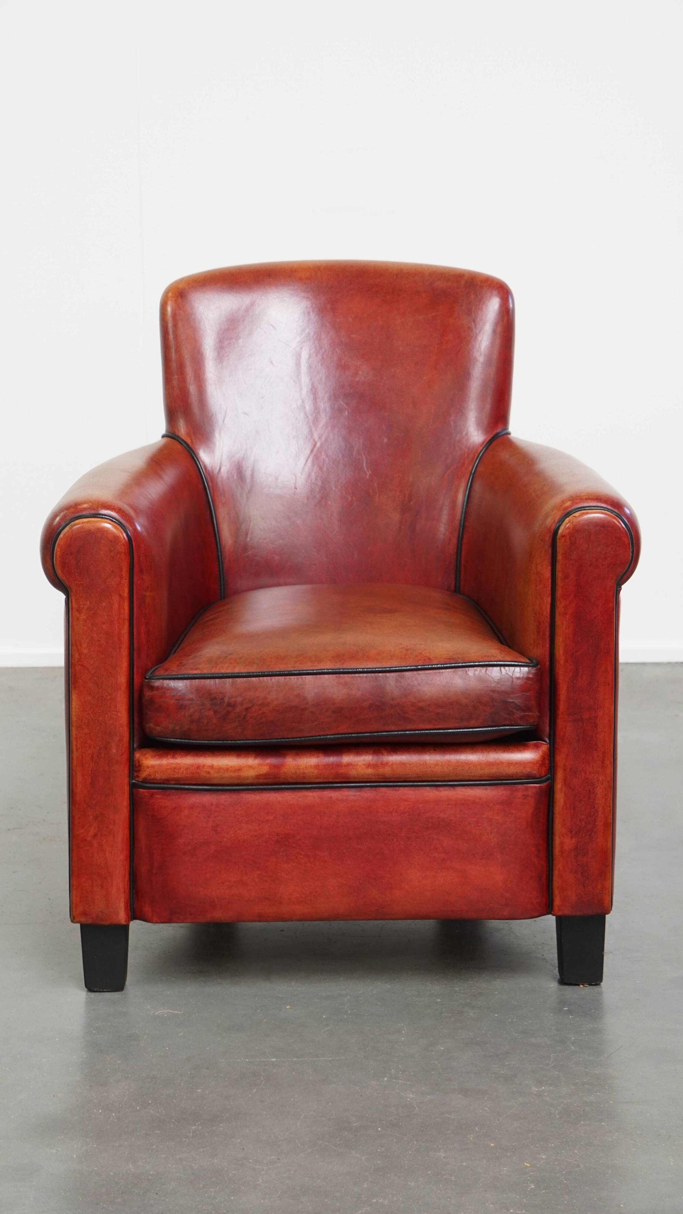 Armchair made of sheepskin leather in a red/brown color