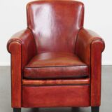 Armchair made of sheepskin leather in a red/brown color