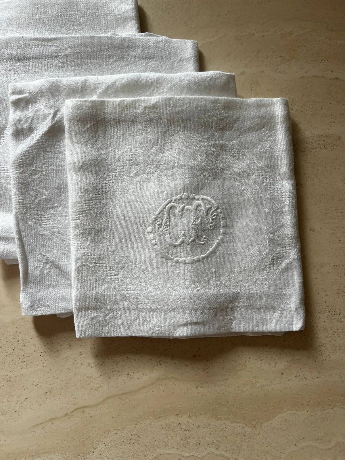 Set of six antique damask napkins with embroidered monogram.