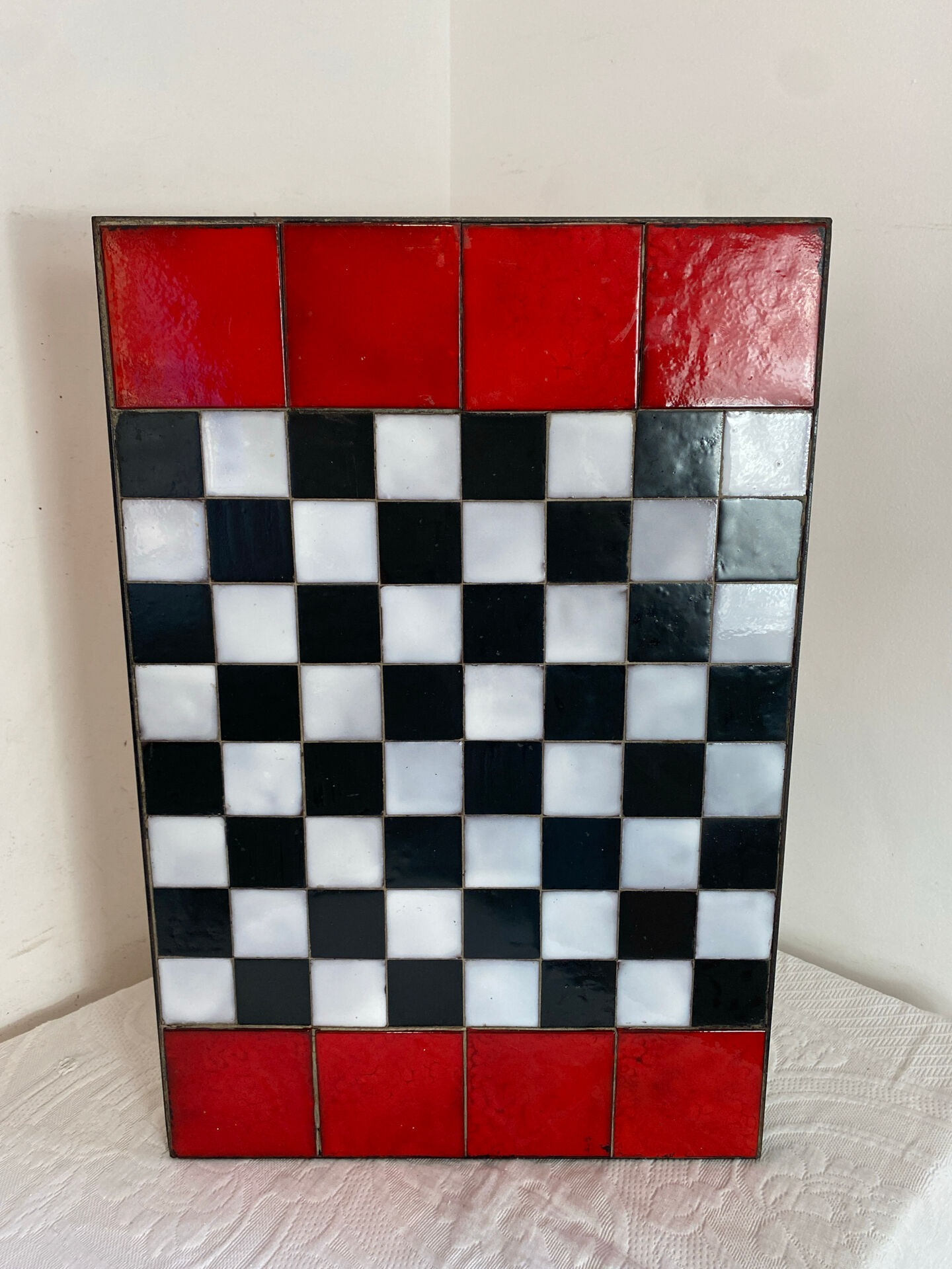 Chess set with ceramic board and pieces.