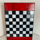 Chess set with ceramic board and pieces.