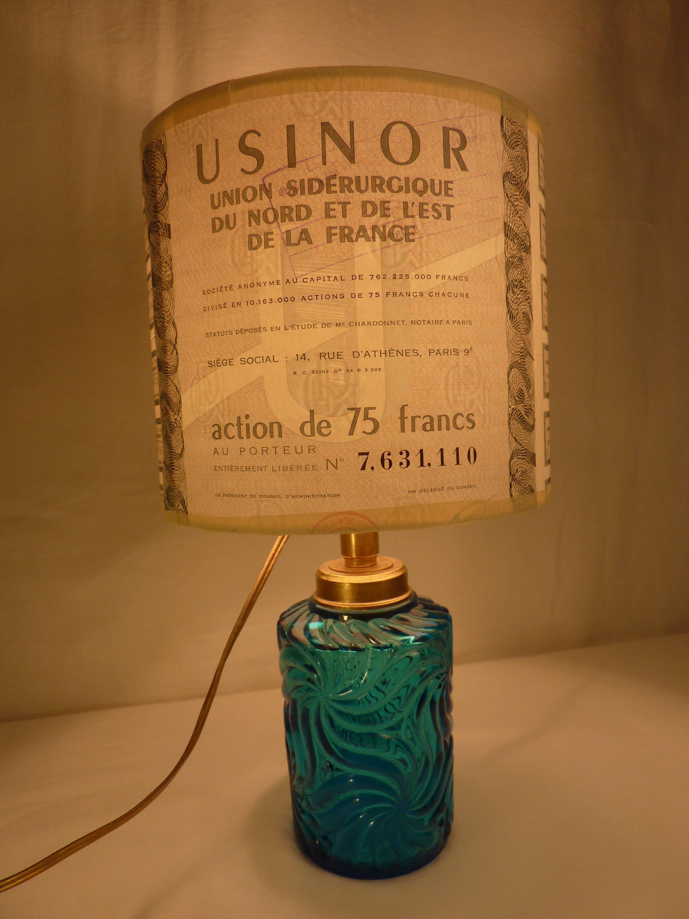 Table lamp with king blue and gold glass foot and machineinor action lampshade