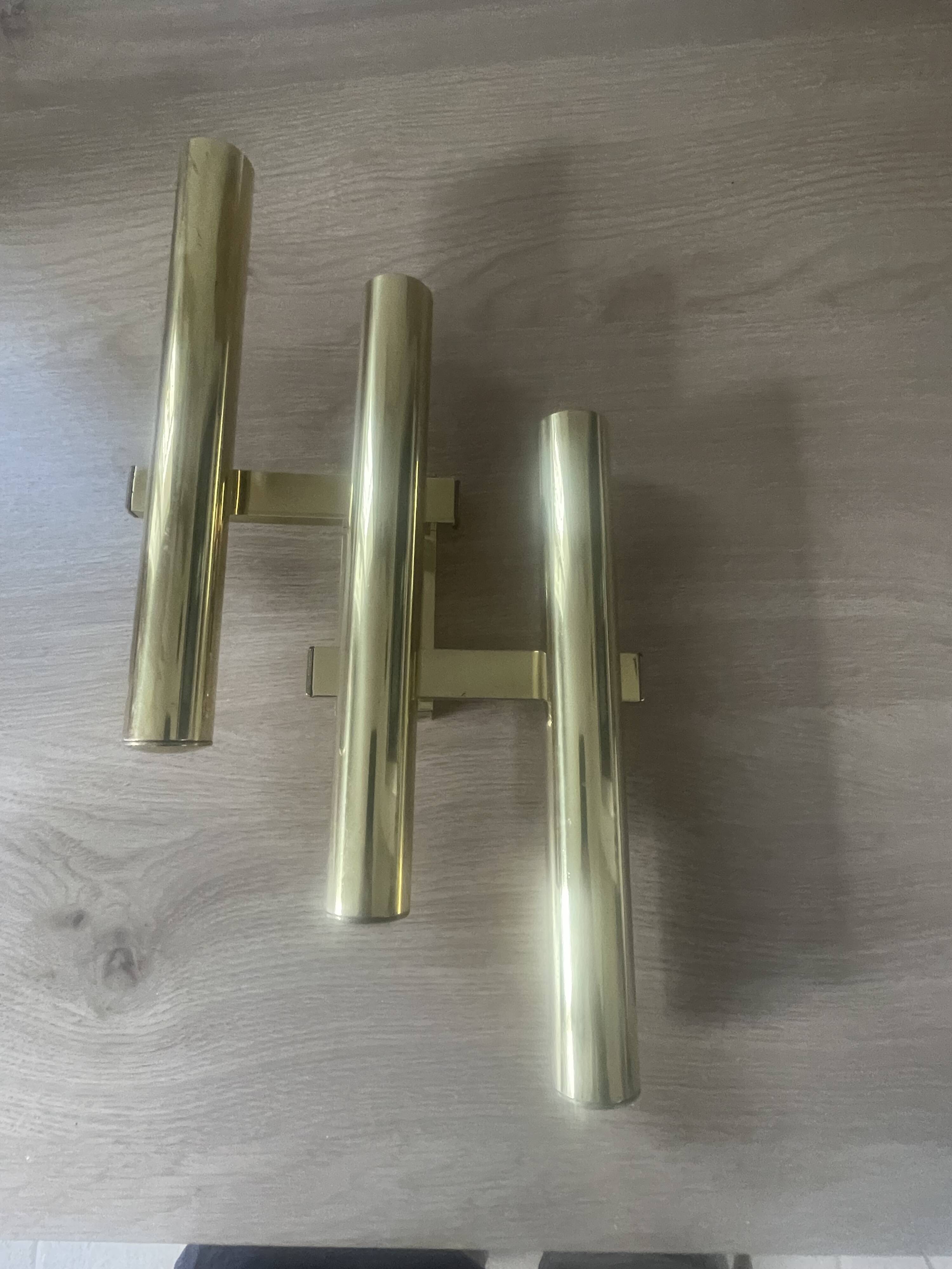 Tubular wall sconces in brass, Italian design from the 1970s, attributed.