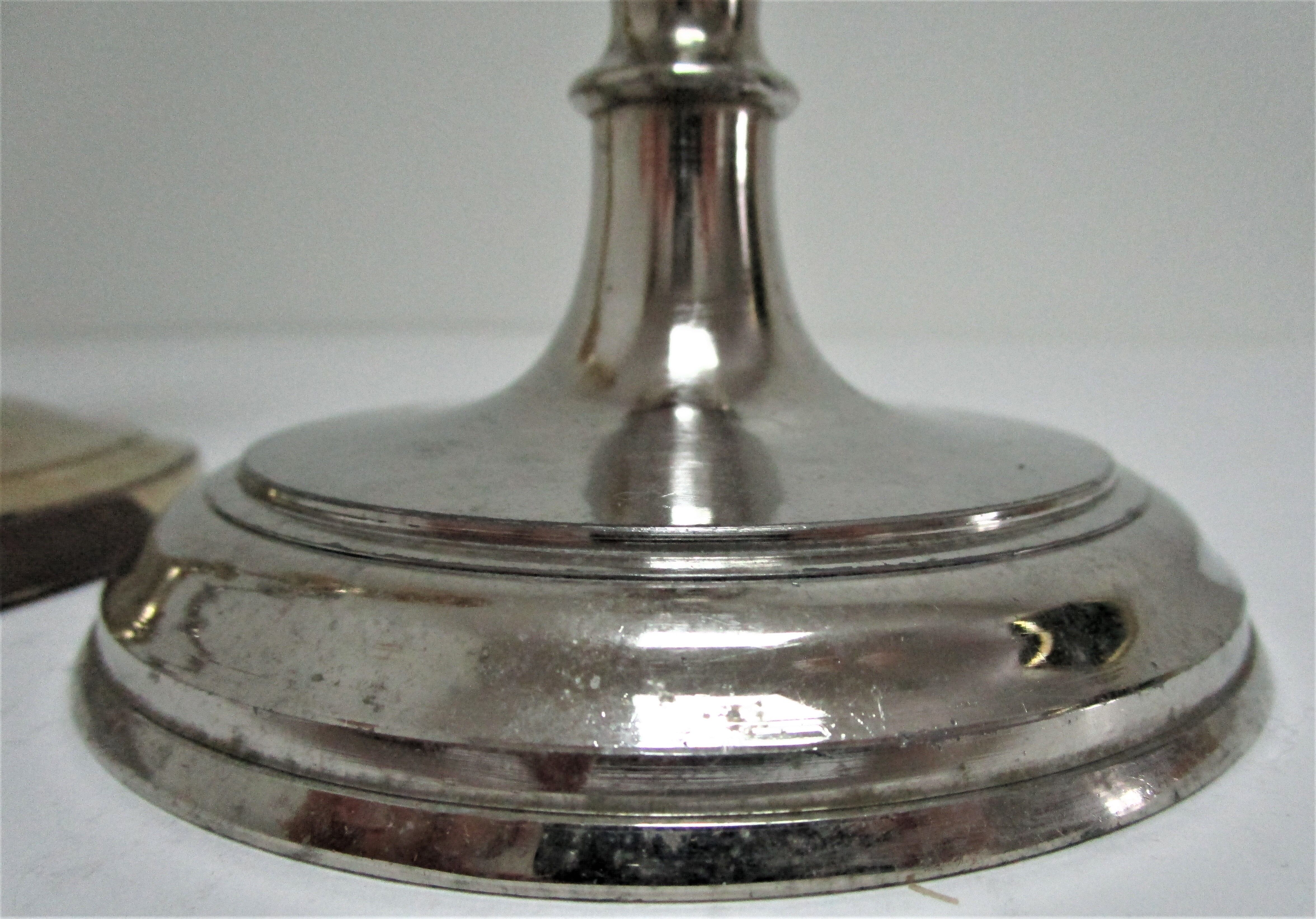 three brass and chrome candle holders early twentieth century