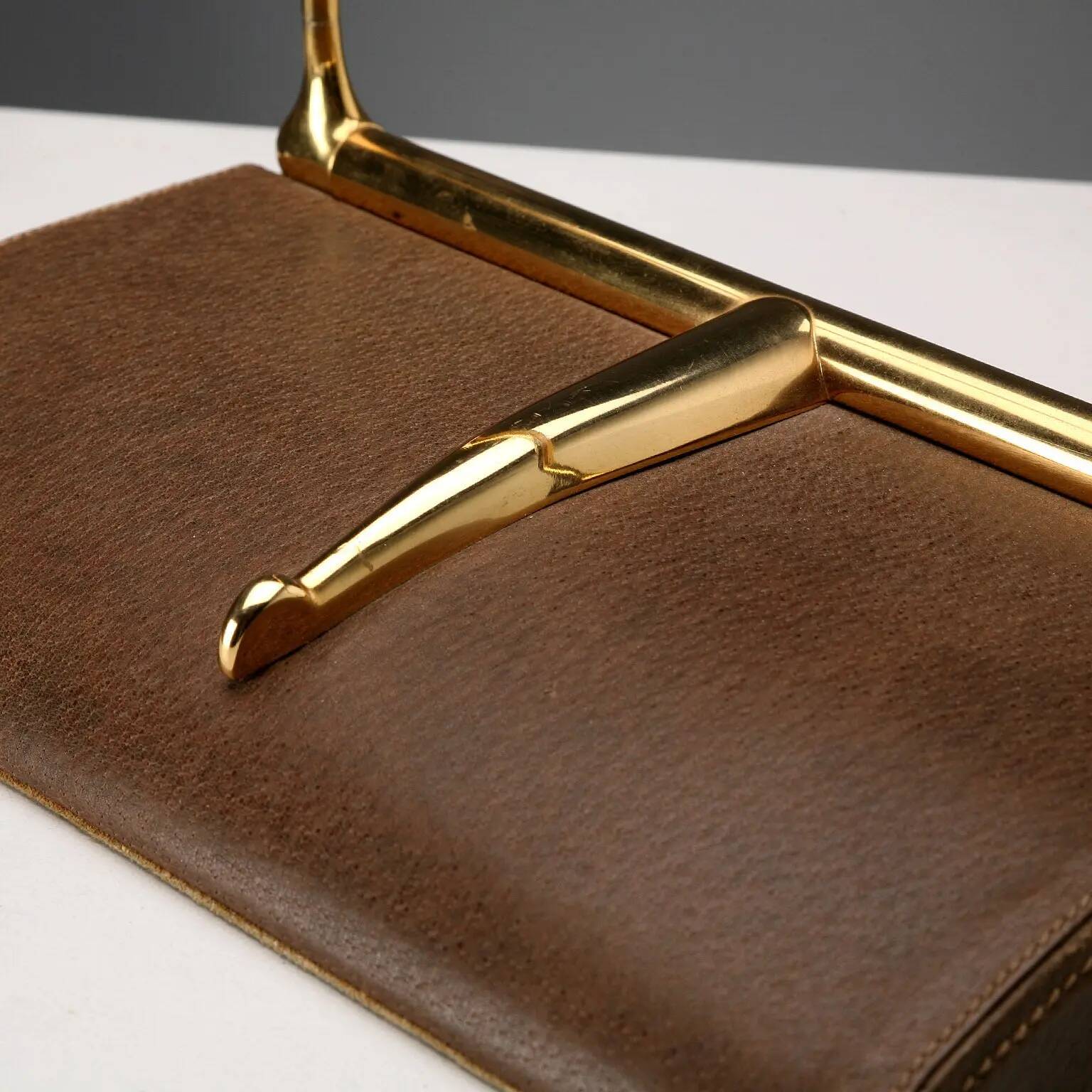 Vintage Gucci bookends in leather and brass, Italy, 1970s.