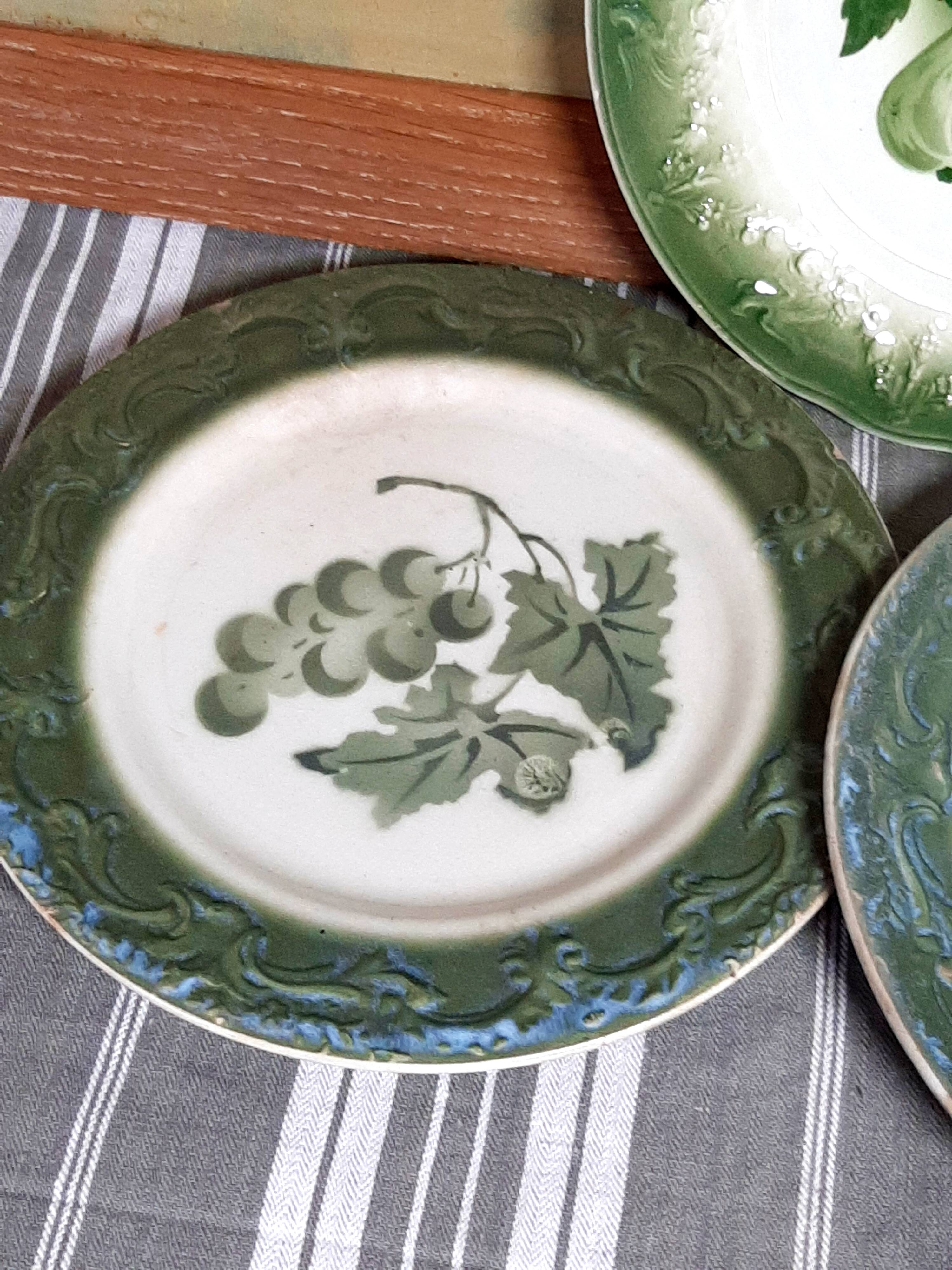 Antique earthenware plates with fruit decoration.