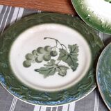 Antique earthenware plates with fruit decoration.