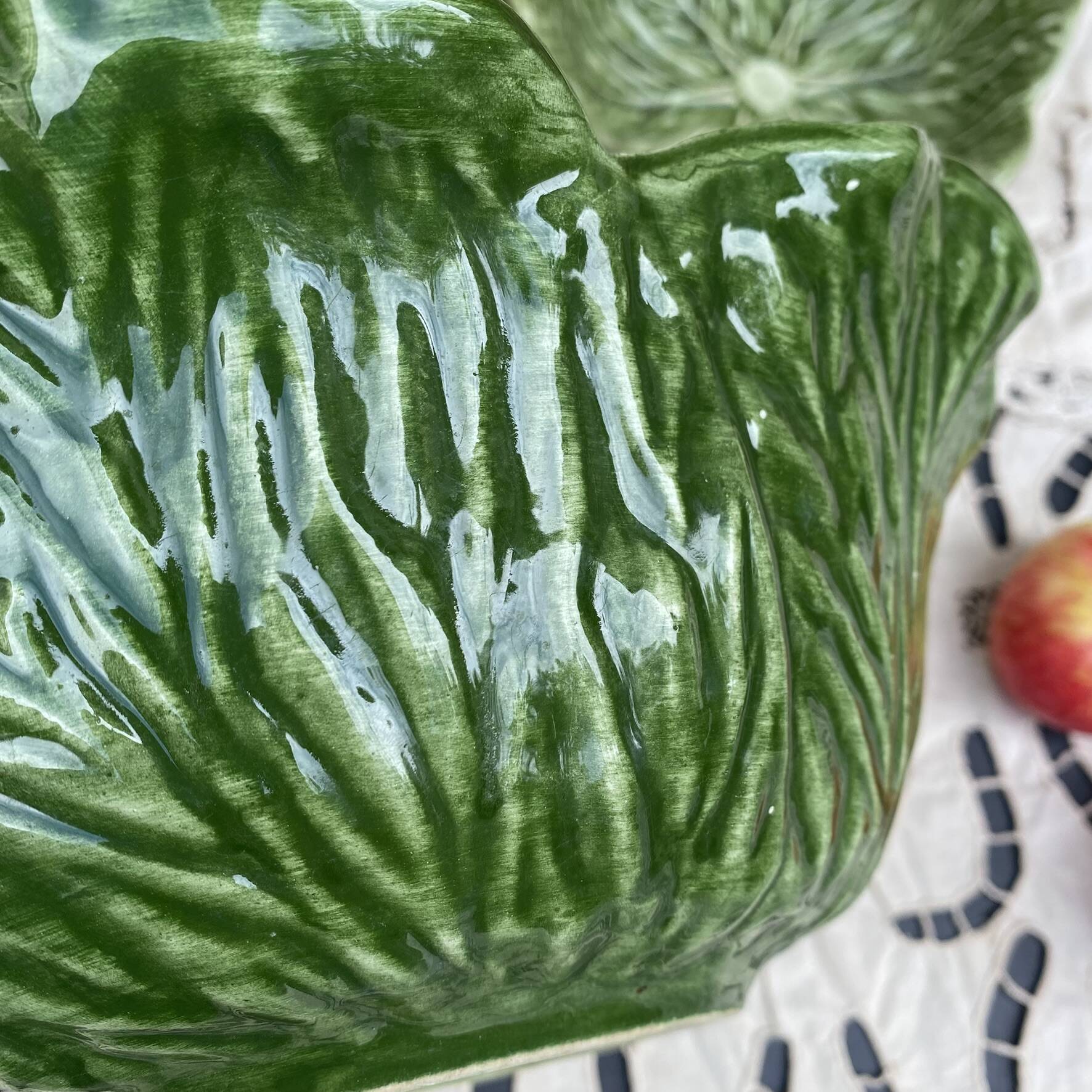 Large earthenware salad bowl in the shape of a cabbage leaf.