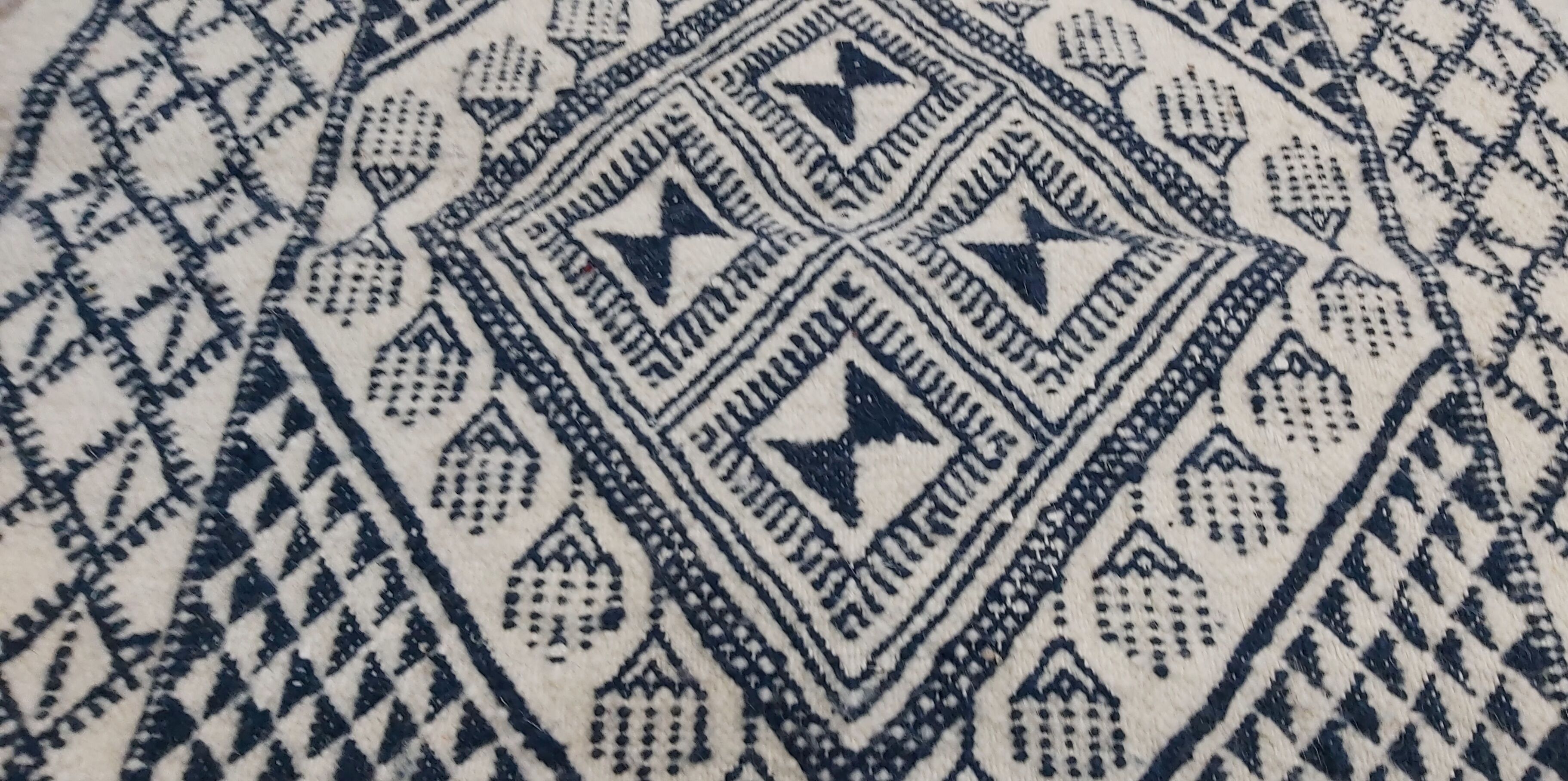Traditional white and blue hand-woven wool carpet