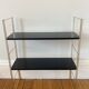 Black and gold string shelf