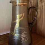 Vintage smoked glass carafe with gold from the 50s/60s, featuring a marine and water skiing design.