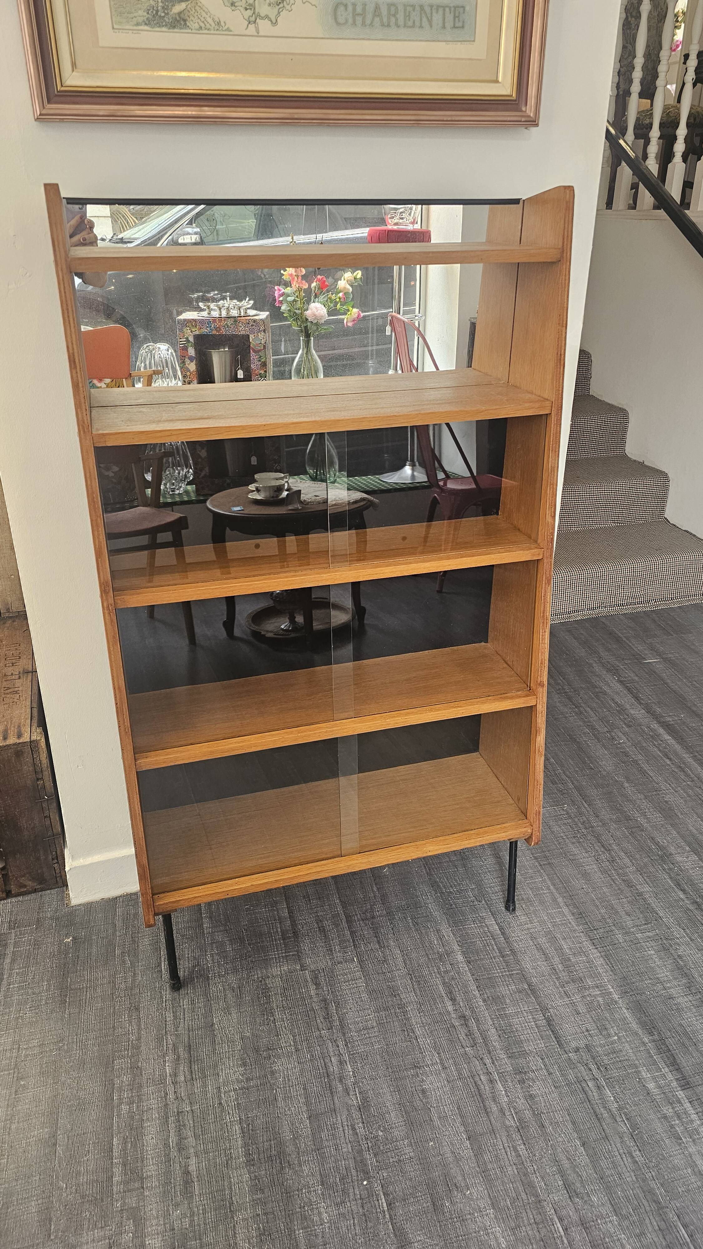 Modernist showcase library with sliding glass doors