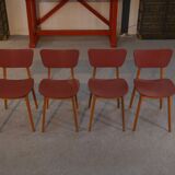 Set of 4 designer chairs in oak and red leatherette from the 1960s