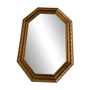 Octagonal gold mirror with copper reflections.