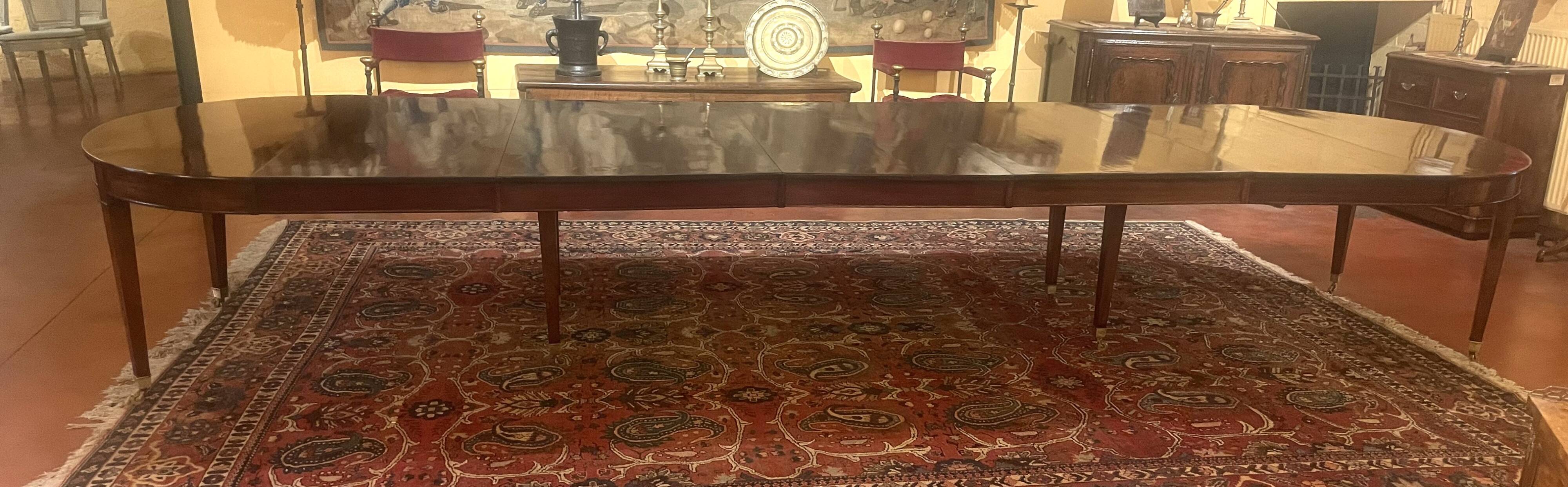 Extensible dining table from the Louis XVI period in mahogany with a banded top.