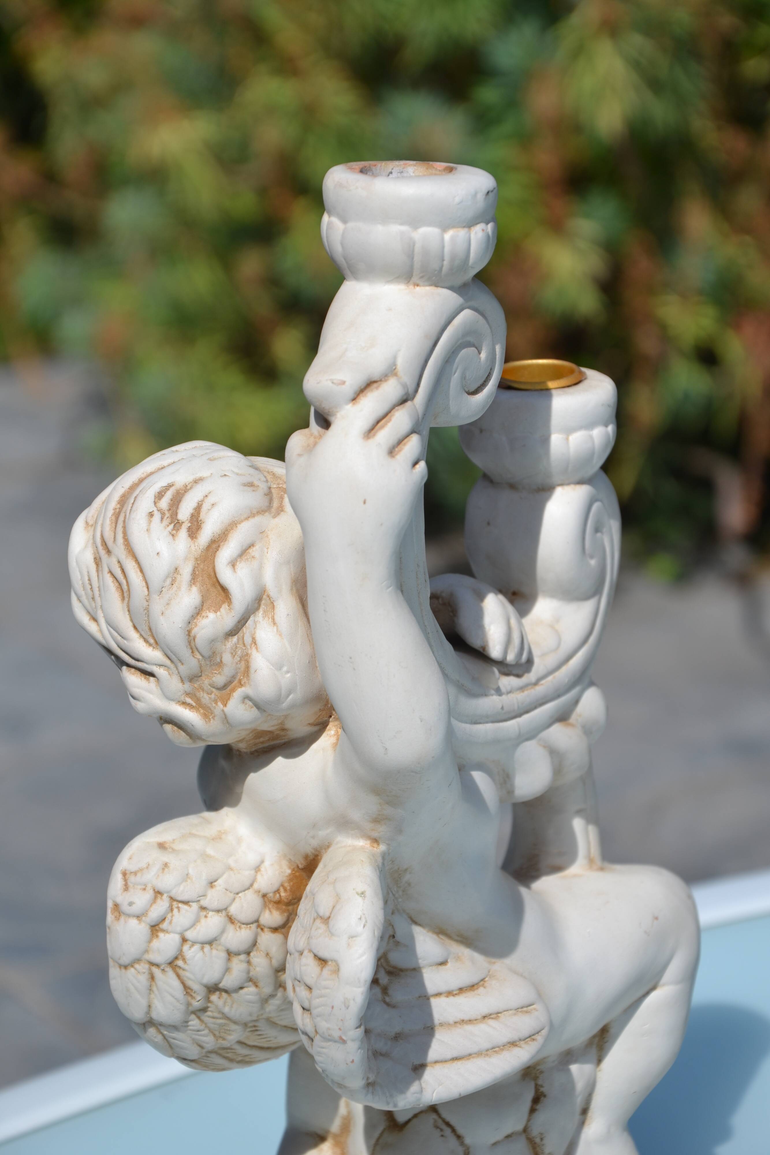 Pair of "cherub" candle holders in plaster