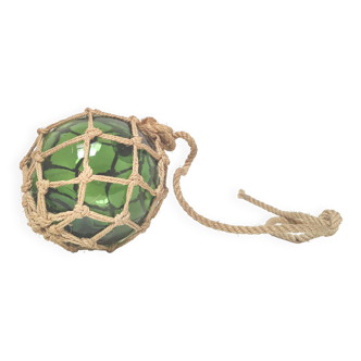 Green ball marine float in glass and rope