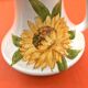 Antique glazed ceramic pitcher with sunflower decoration