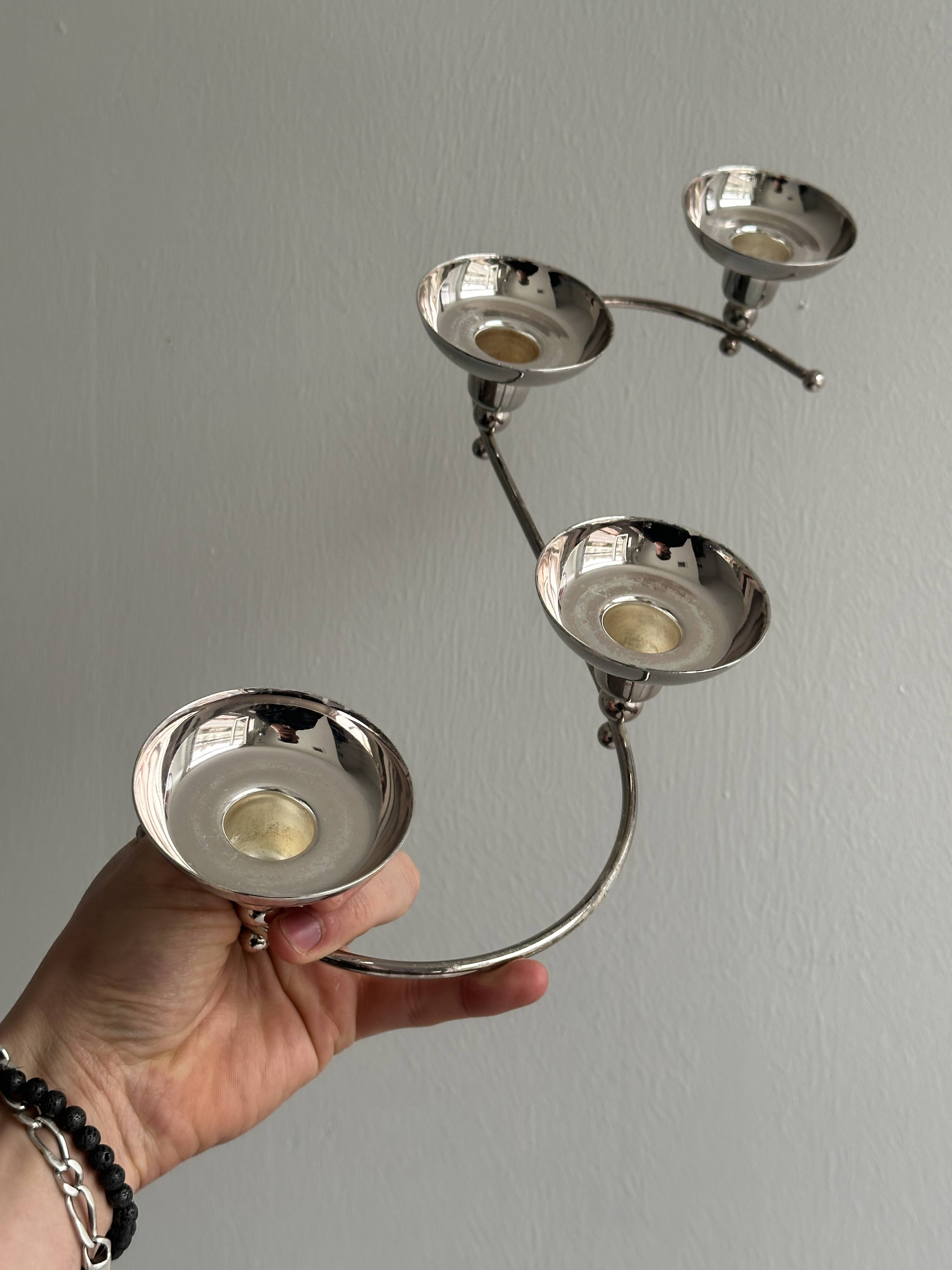 Shiny stainless steel candlestick holder