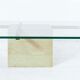 Coffee table with travertine gold-plated cross base and glass top