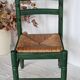 Vintage children's chair in green wood with a woven straw seat