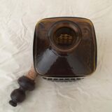 Old amber glass bottle with its wooden and cork stopper