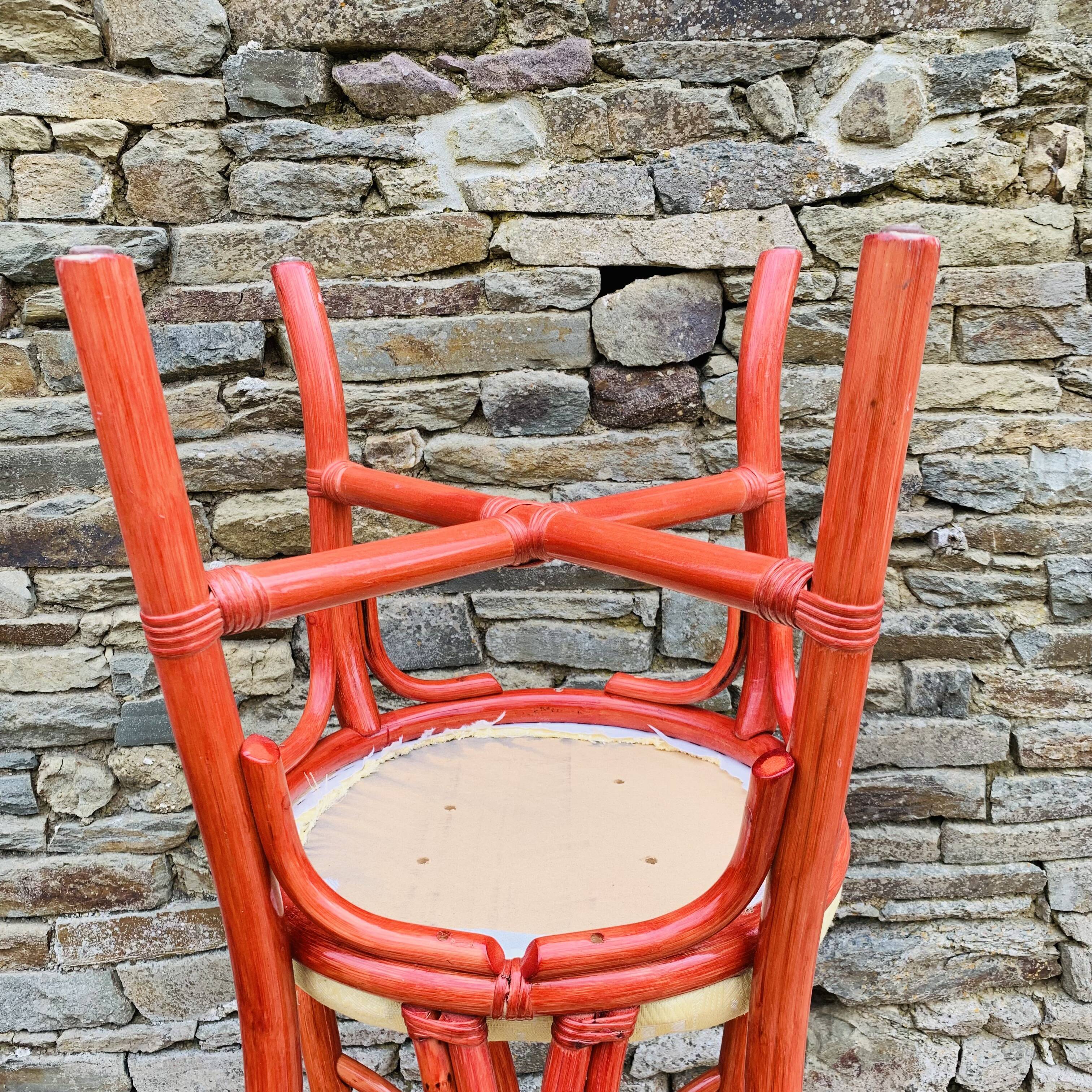 Pair of red rattan chairs and fabric