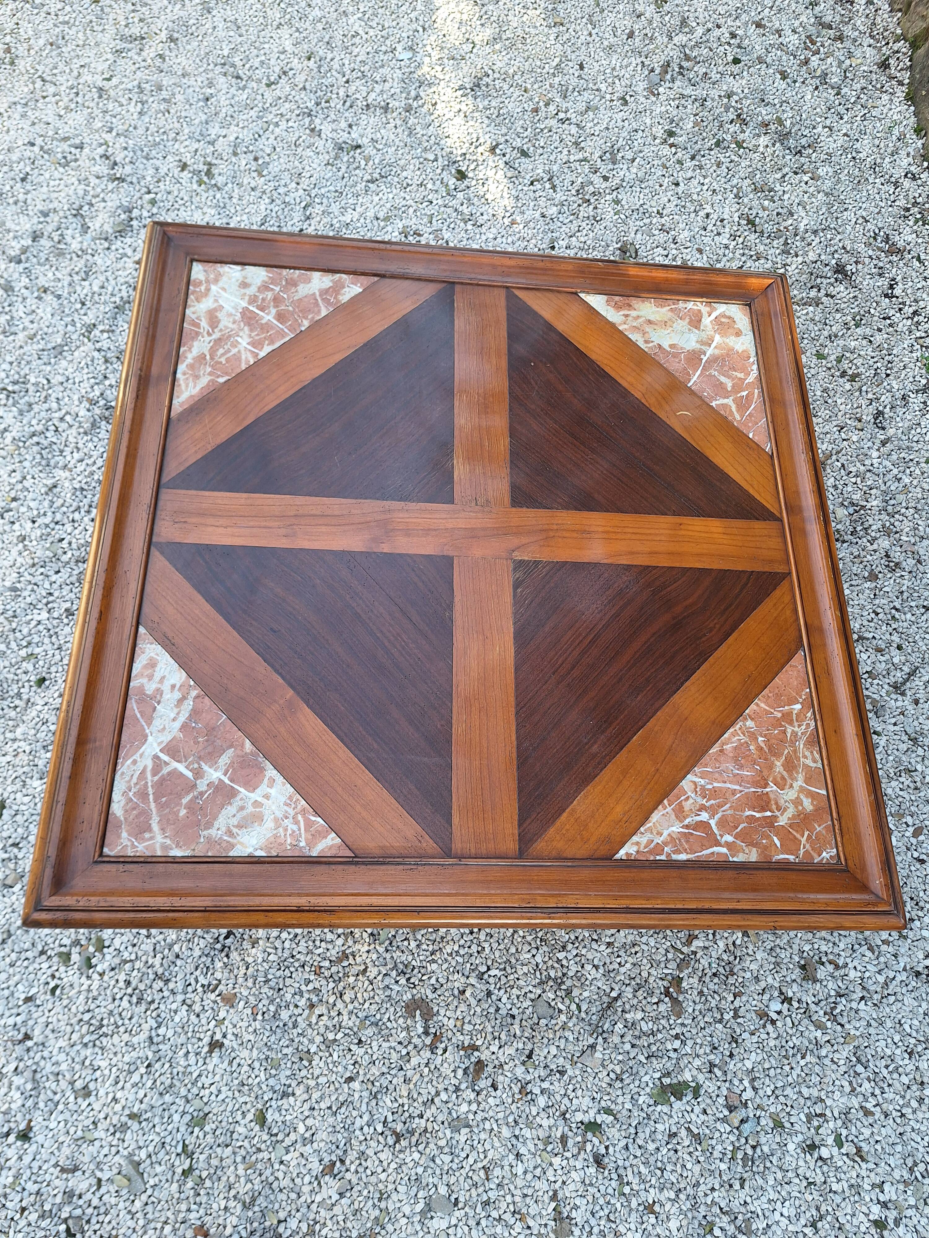 Coffee table with wood marquetry and marble inlays.