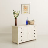 Small accent cabinet with drawers and swing doors