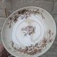 Flat serving compote dish in Terre de Fer HB & Cie with brown floral decoration.