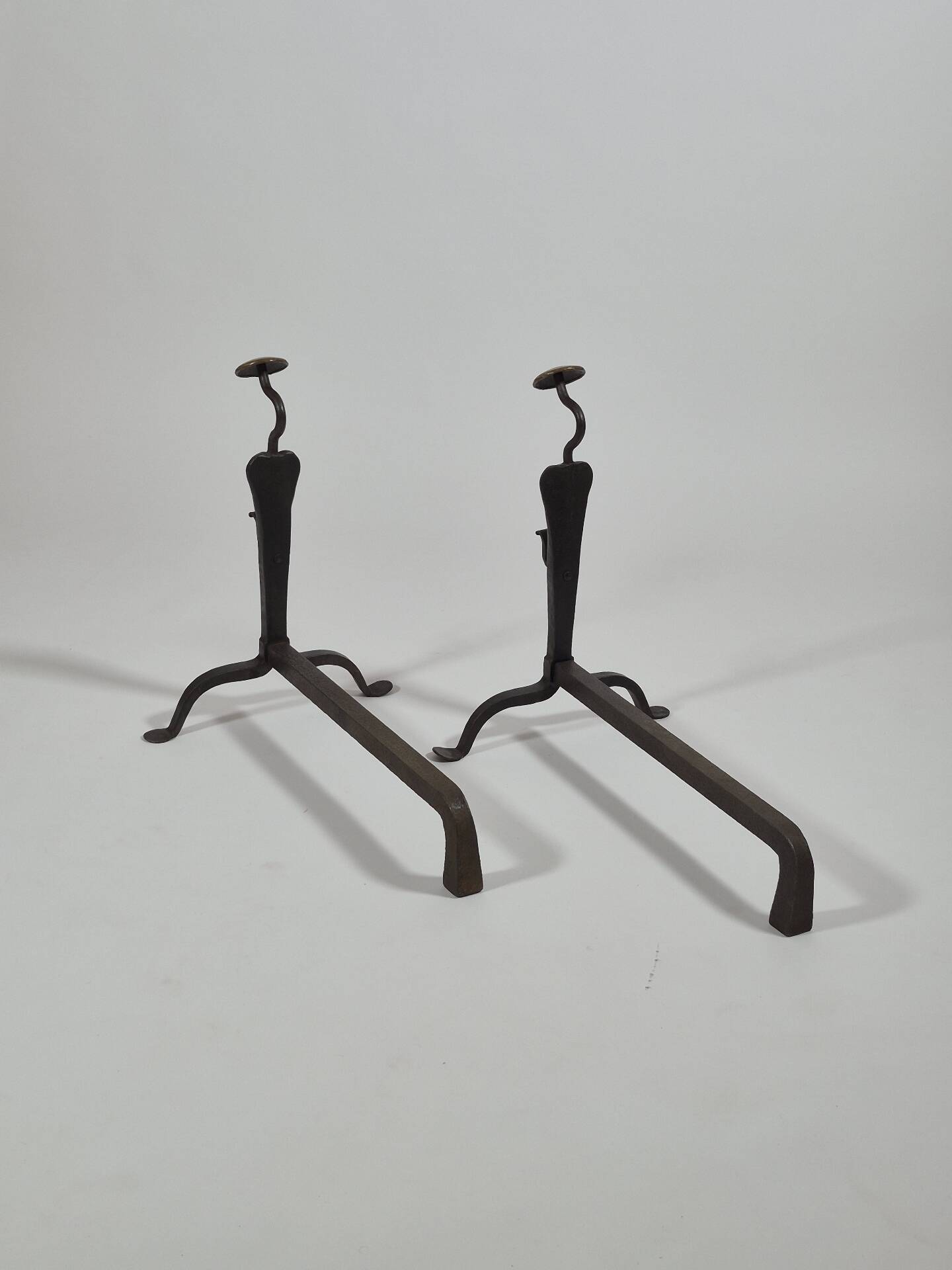 Pair of handforged metal and brass andirons
