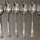12 small Christofle Marly silver-plated spoons in the mascaron pattern.