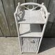 Small white wicker bathroom shelf