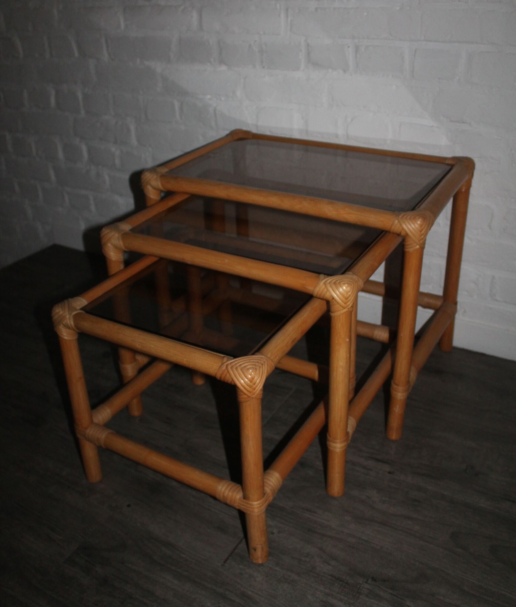 Rattan nesting tables in rattan and smoked glass from the 70s