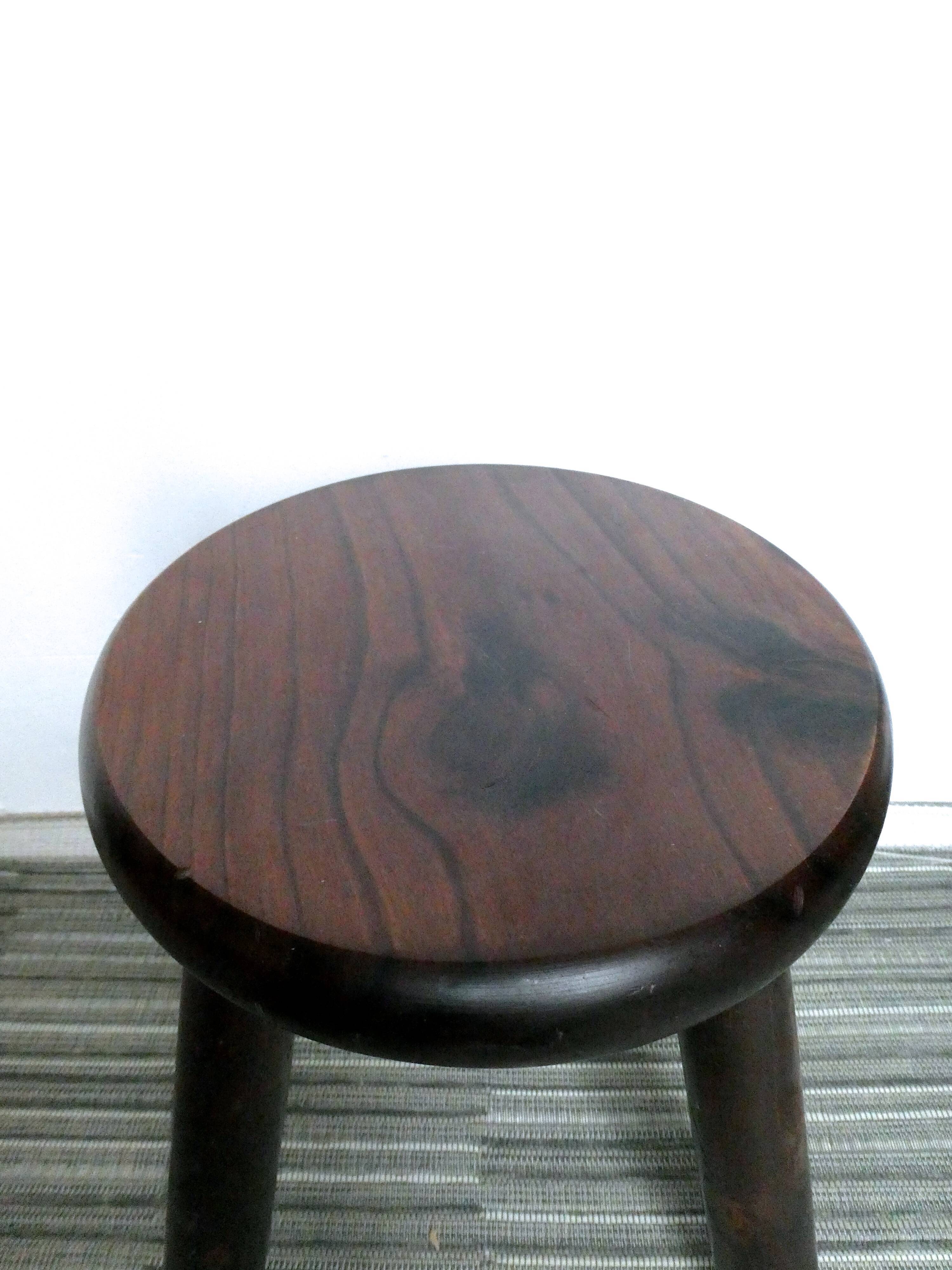 Dark wooden tripod stool