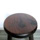 Dark wooden tripod stool