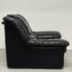 Vintage black leather lounge chair — low postmodern club chair from the space age.