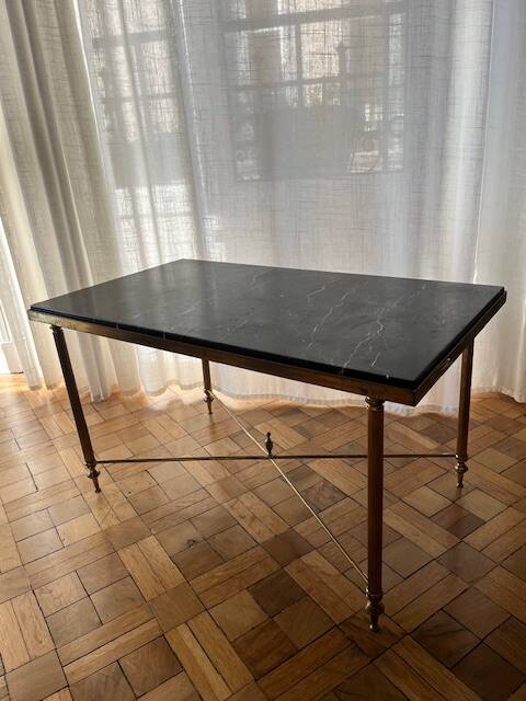 Black marble coffee table with brass legs.