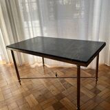 Black marble coffee table with brass legs.