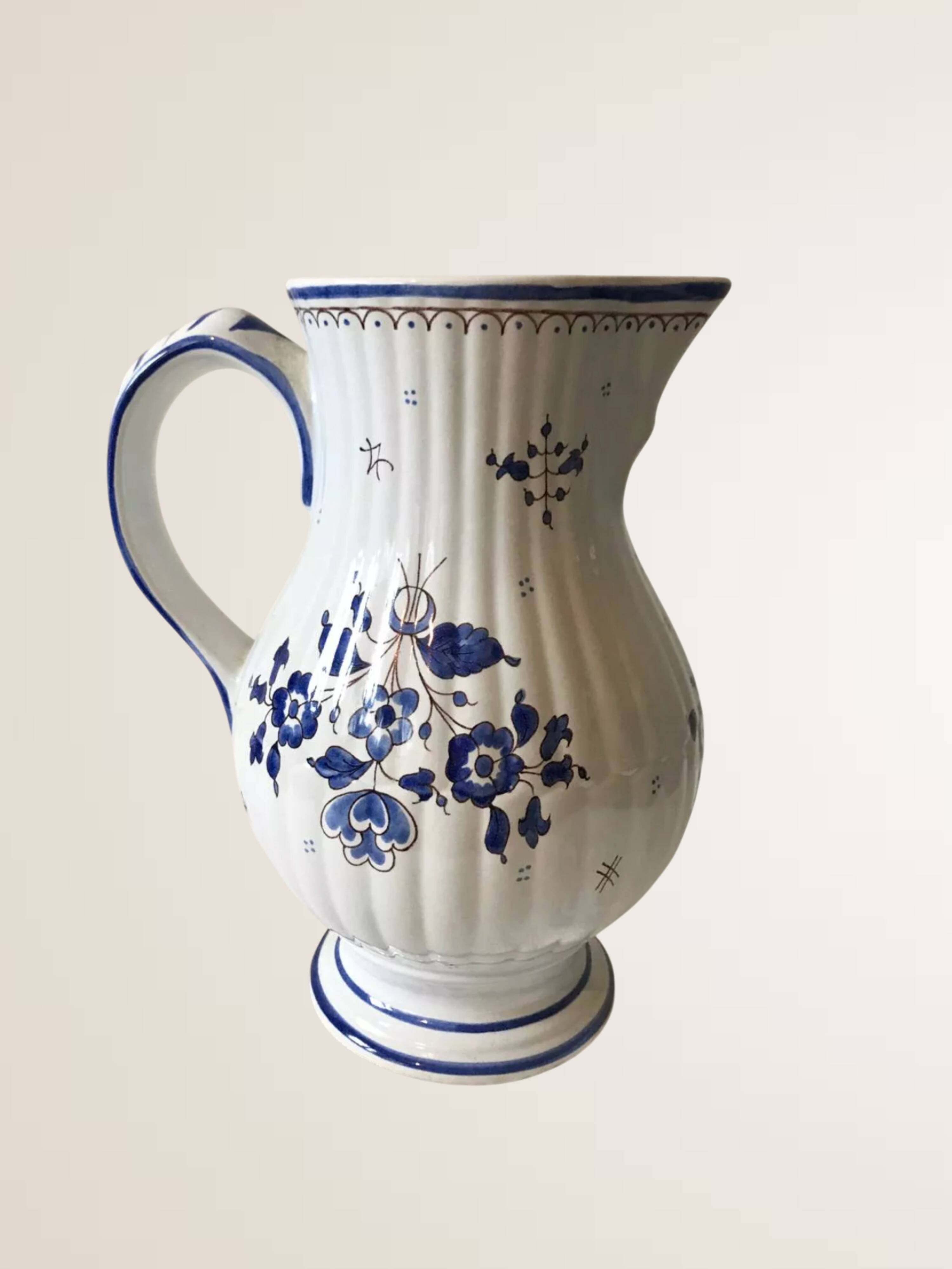 Moutiers earthenware jug, hand-painted blue decoration.