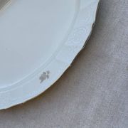 Large yellow porcelain serving dish by Bernadotte from the 1960s, with a gold rim and relief.