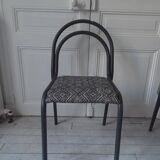 Industrial chair with a tubular metal frame in slate grey.