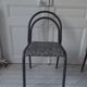 Industrial chair with a tubular metal frame in slate grey.