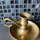 Two brass hand candle holders