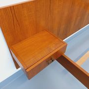 Double bed vintage modernist in teak and black metal from the 1960s with bedside tables.