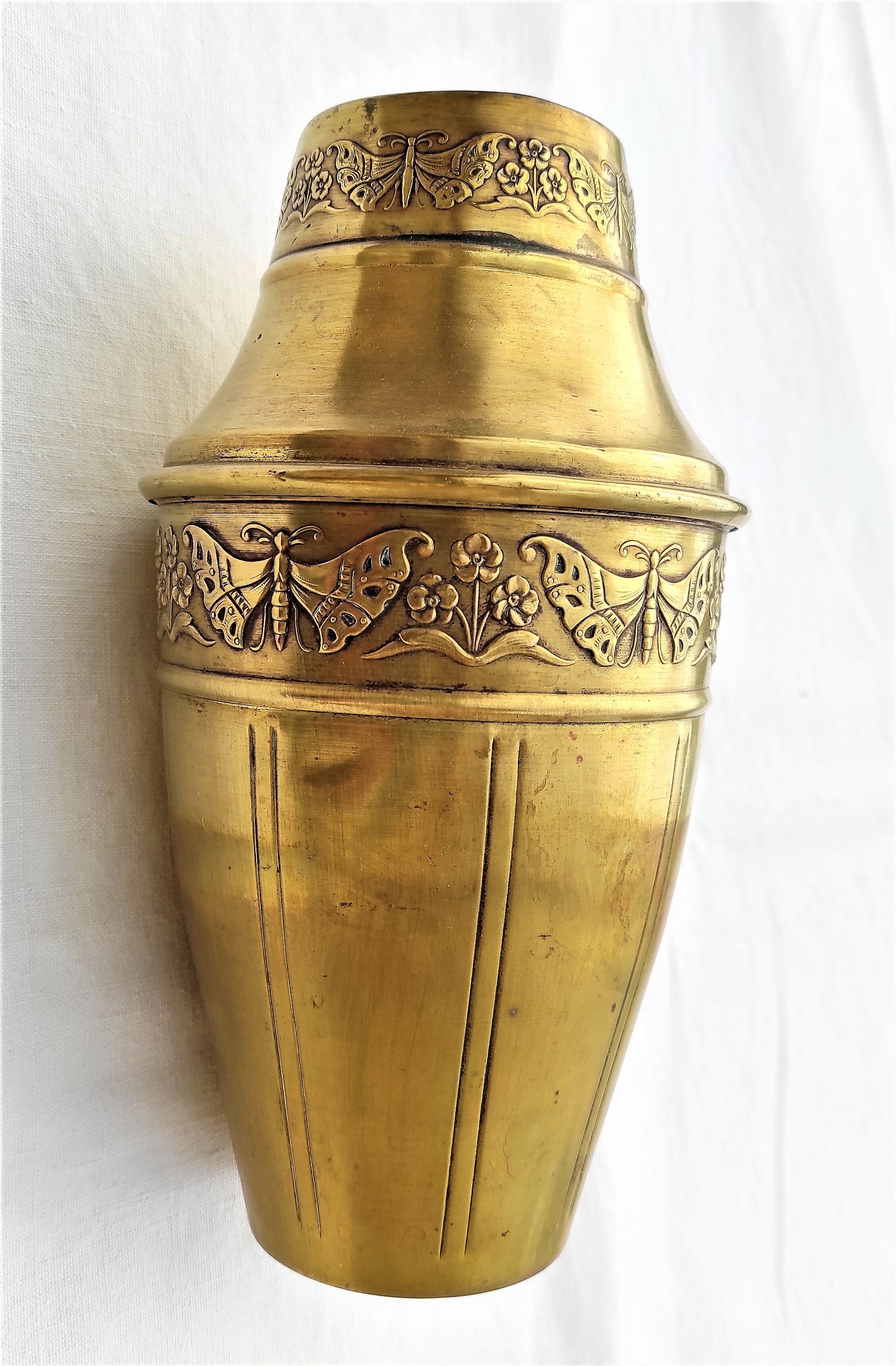 Vase in brass worked with flowers and butterflies around 1930