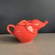 Large coral-coloured elephant teapot.