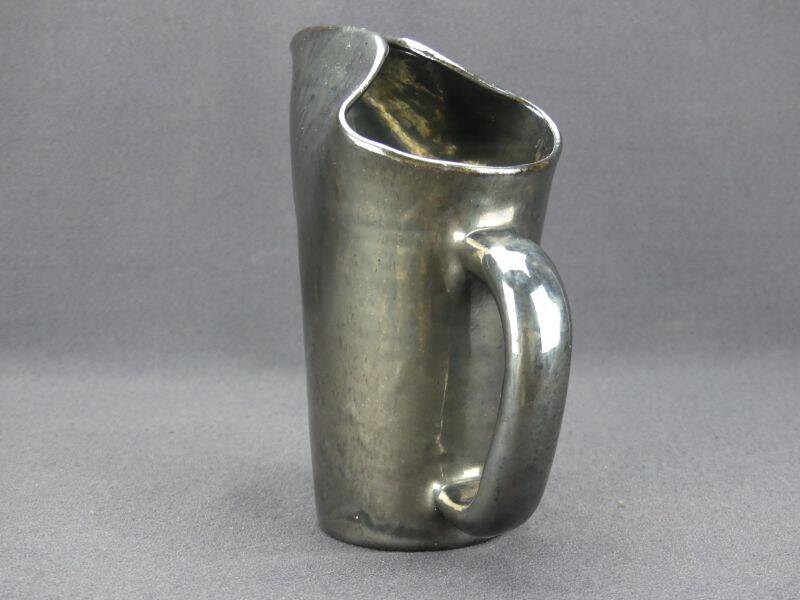 Old Biot, modernist pitcher in iridescent black ceramic.