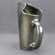 Old Biot, modernist pitcher in iridescent black ceramic.