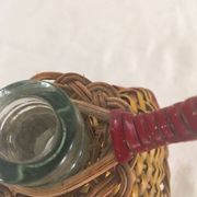 Bottle sheathed on the top and the low d wicker woven